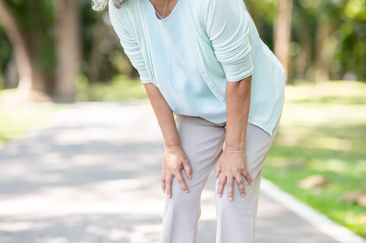 old woman grandmother patient hands holding knee