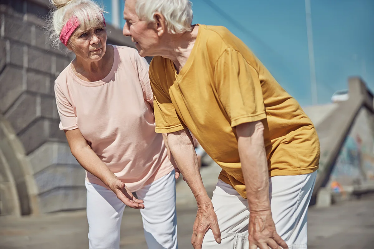 senior couple taking a break from fitness routine